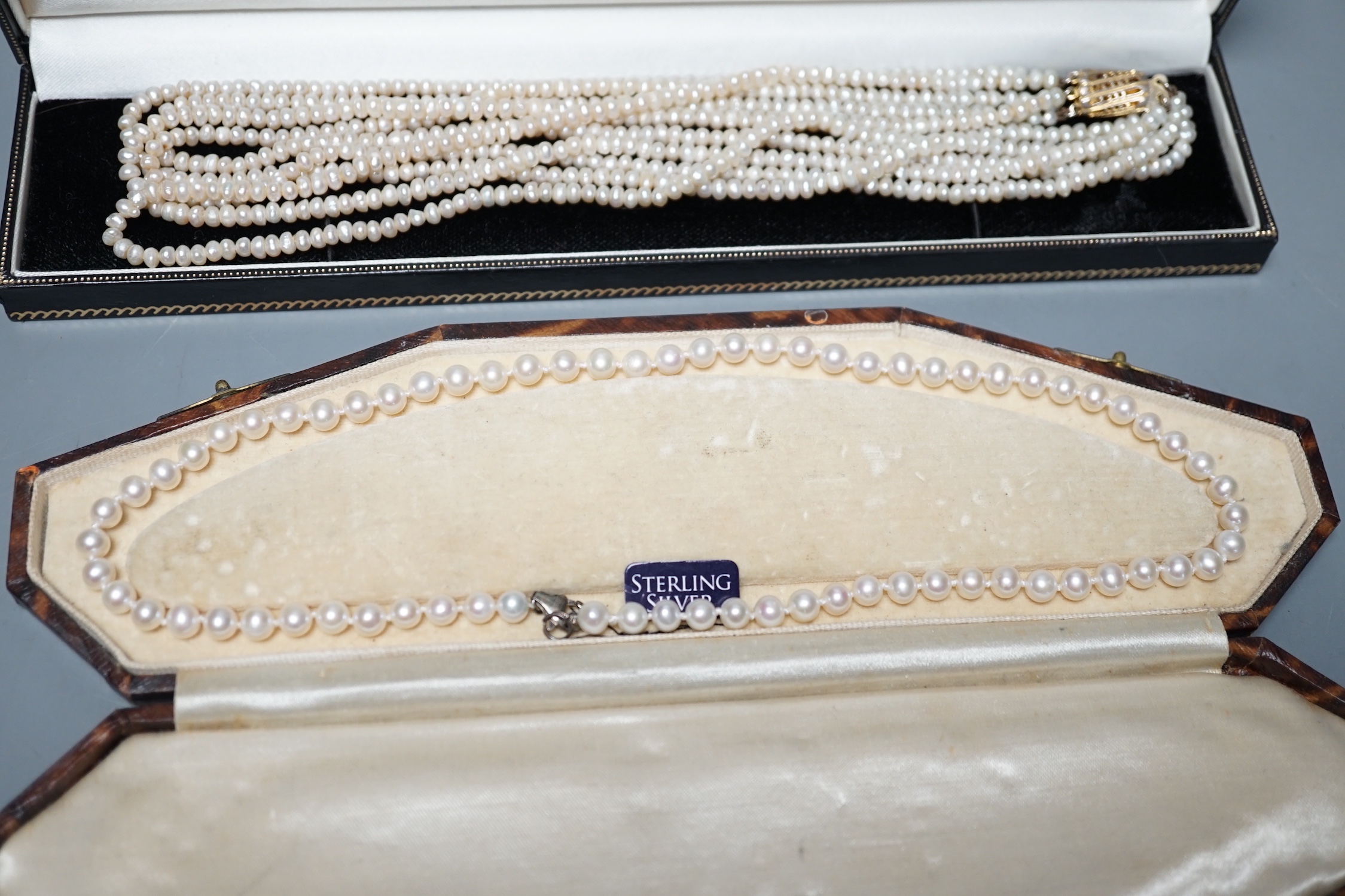 A single strand cultured pearl necklace, with sterling clasp, 44.5cm and a quadruple strand baroque seed pearl necklace, with gilt metal clasp, 42cm.